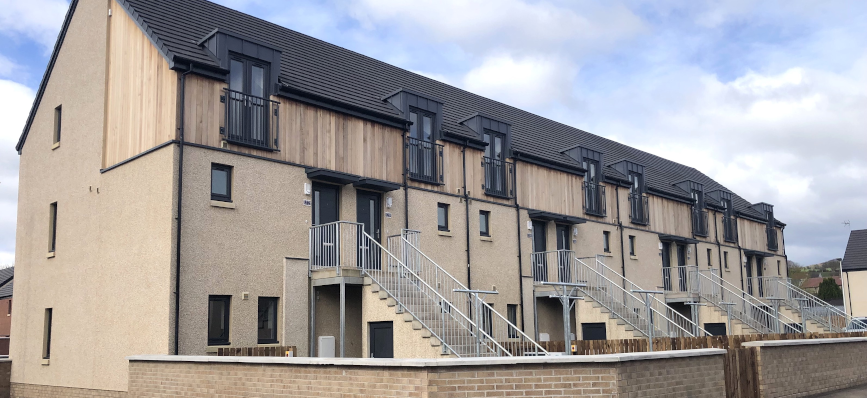 housing development – three brown houses in a row