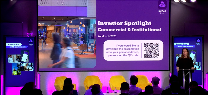 Image of Claire Kane presenting on stage at the Commercial & Institutional Investor Relations spotlight event