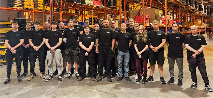 A group photo of the Toolden team in the warehouse