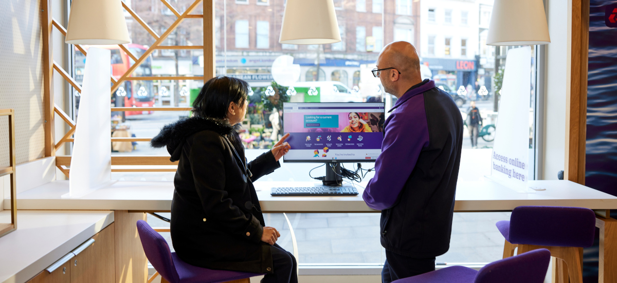 Colleague supporting customer with online banking in a NatWest branch