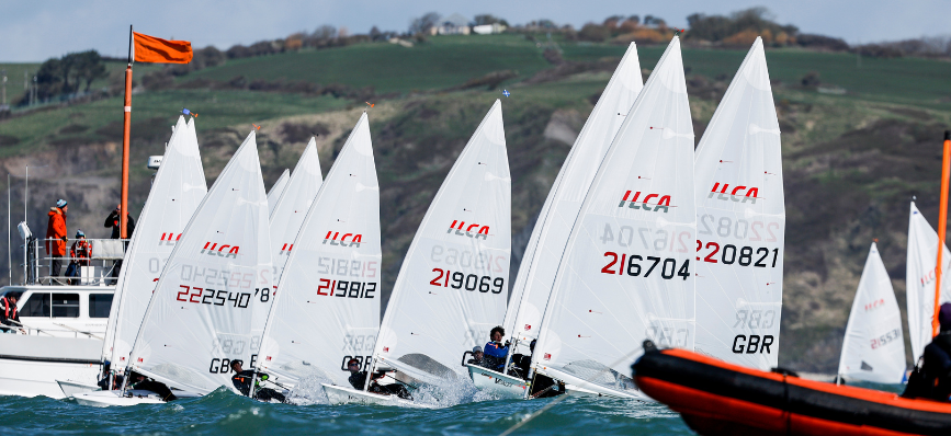 People racing sailing boats