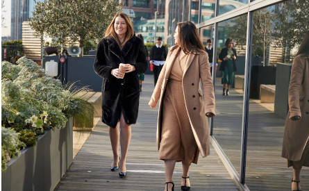 Two colleagues walking into the office