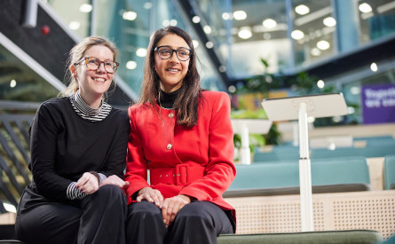 Two colleagues sitting on a bench in London office