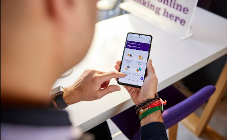 View from above of hands holding a mobile phone to find banking services