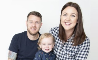 This image shows a NatWest Group colleague with his partner and their child sitting between them.