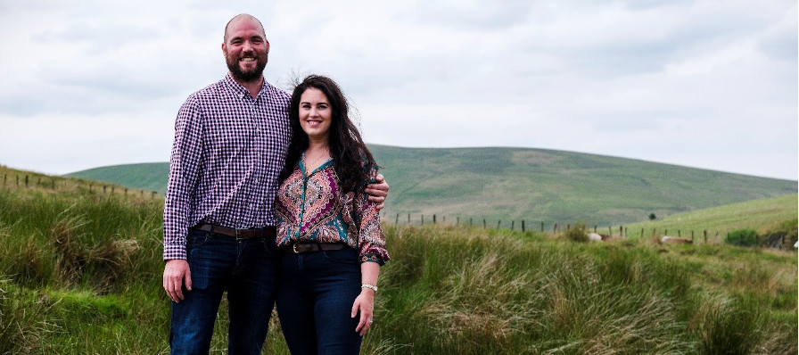 Photograph of the husband and wife farming team in their field 