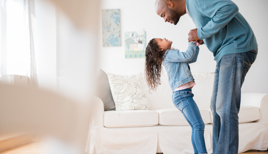 Daughter standing with father