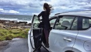 Woman in car looking at UK coastline