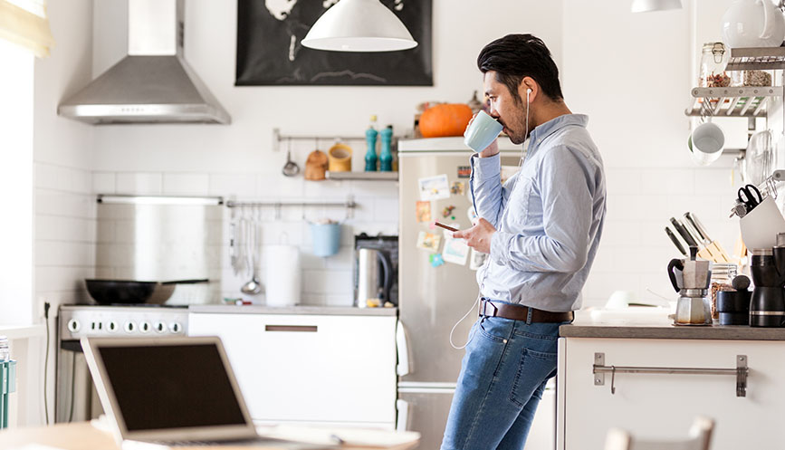 Man drinking coffee listening to podcast