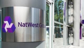 A post with a metal sign saying NatWest group on