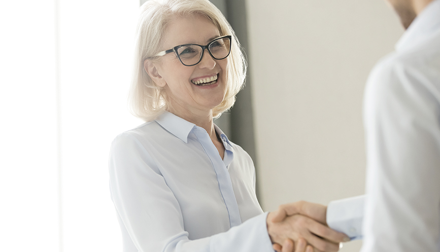 nw-group-photo-businesswoman-in-white-shirt-haking-hands-with-a-man-867x497.jpg