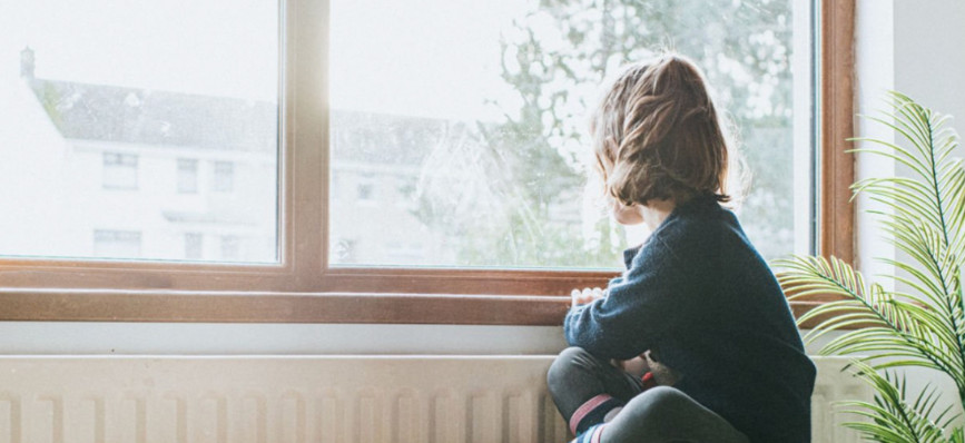 Child looking out of a window