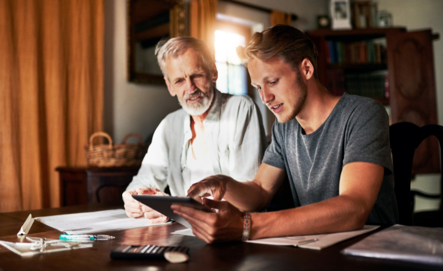 Two people viewing information on a tablet