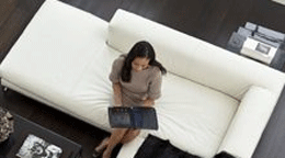 Person reading on a white sofa
