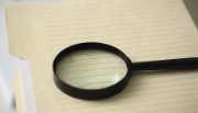Magnifying glass on notebook