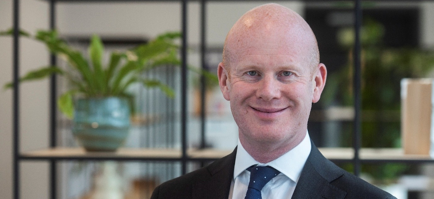 Portrait image of Andrew Harrison dressed in a dark suit and tie