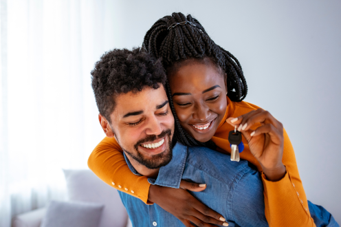 man and a woman holding a set of keys