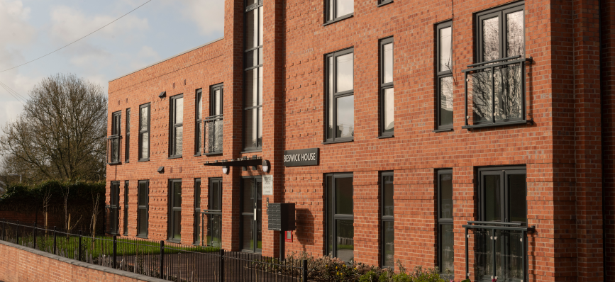 a red brick three story social housing building