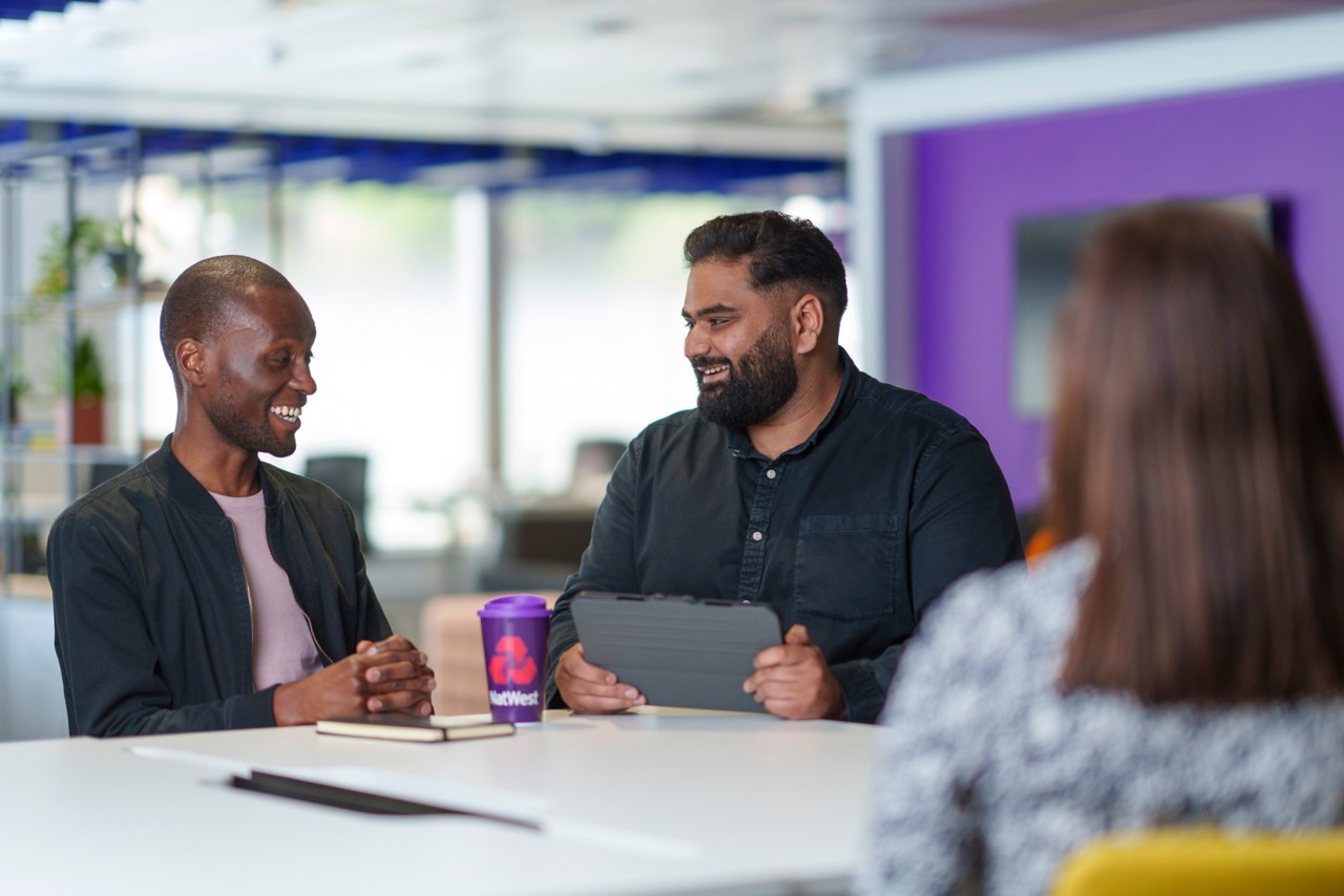This image shows NatWest colleagues sat down alongside a member of the NatWest Accelerator hub. 