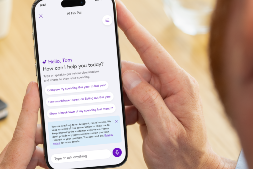 This image shows a person holding a mobile phone engaging with NatWest’s spending insights tool.