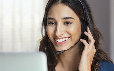 Woman wearing a telephone head-set smiling